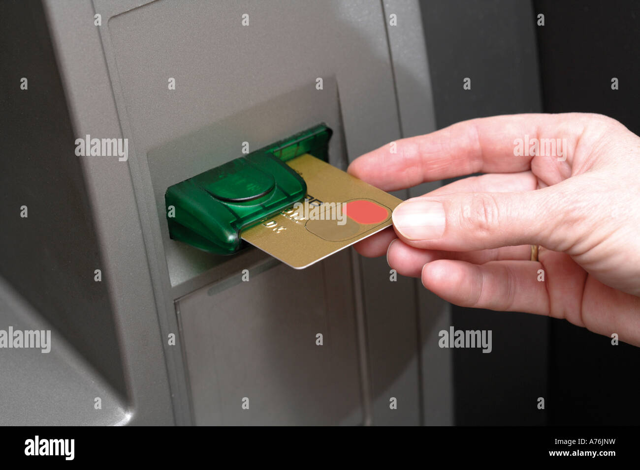 Hand pushing credit card into cash terminal, close-up Stock Photo