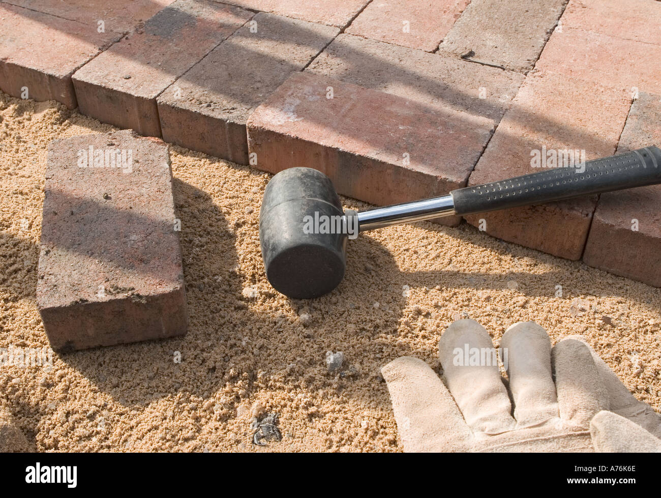A semi complete section of block paving on a bed of dry mortar with