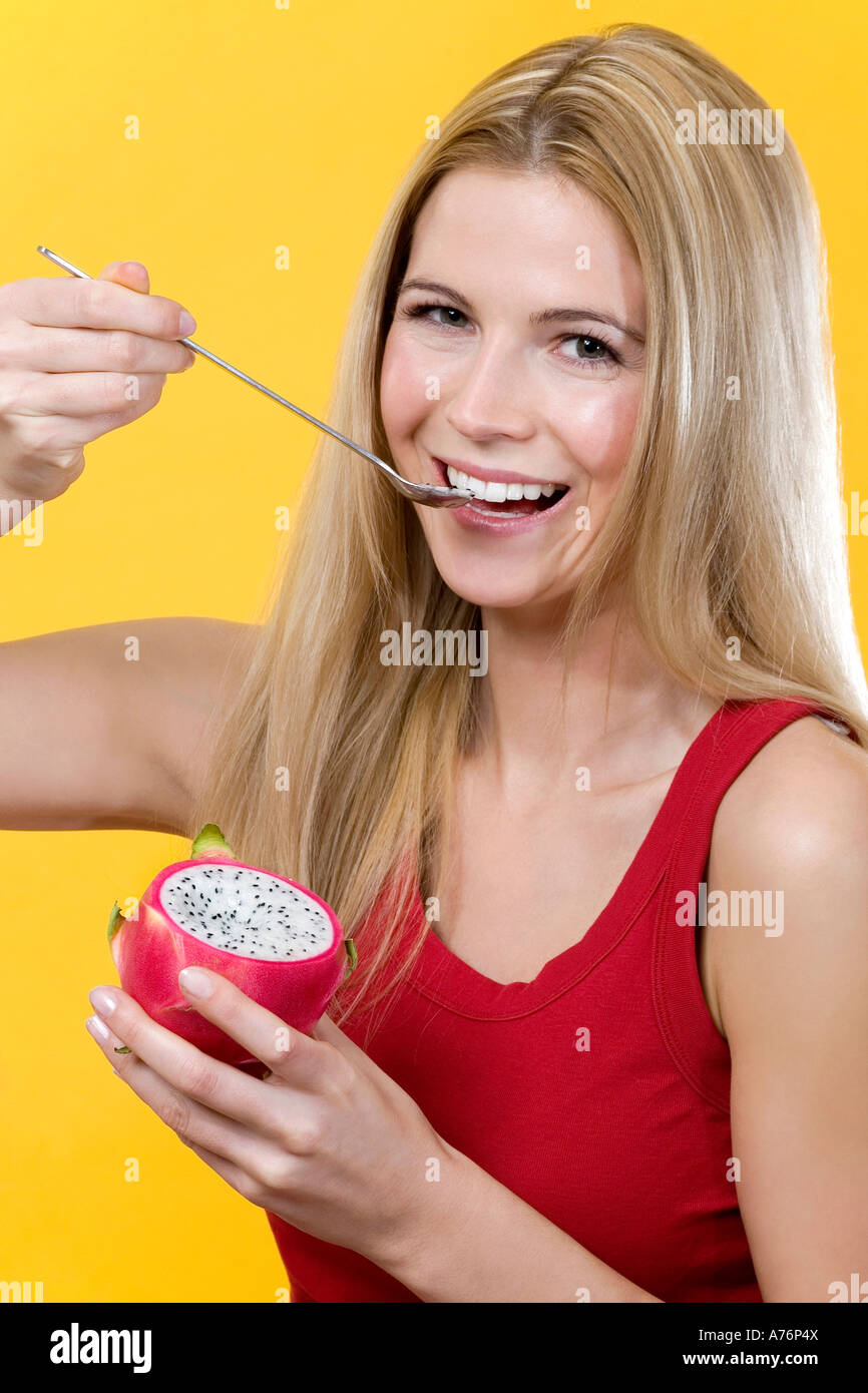 Woman eating pitahaya Stock Photo - Alamy