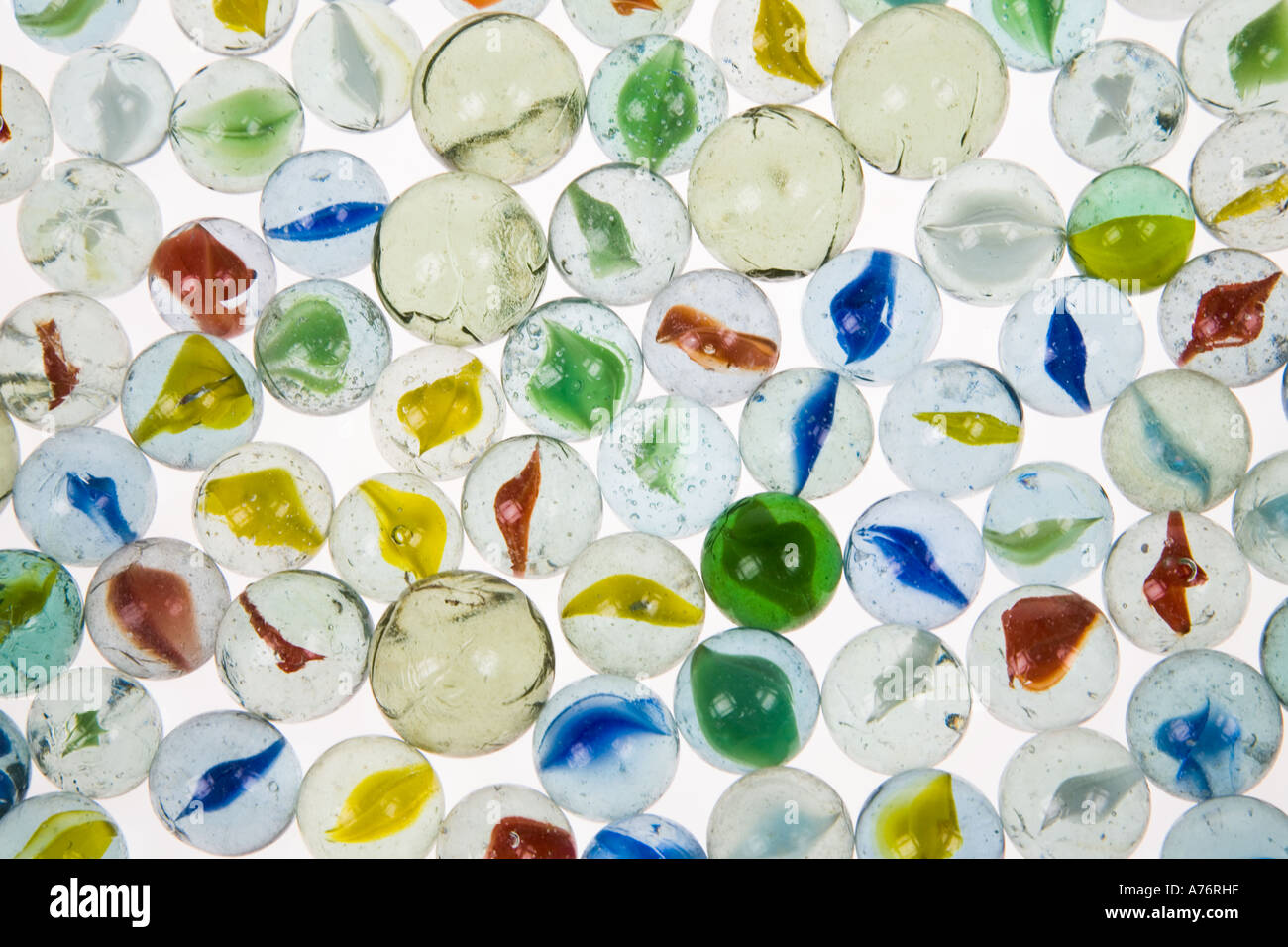 Traditional coloured glass marbles on white background Stock Photo - Alamy