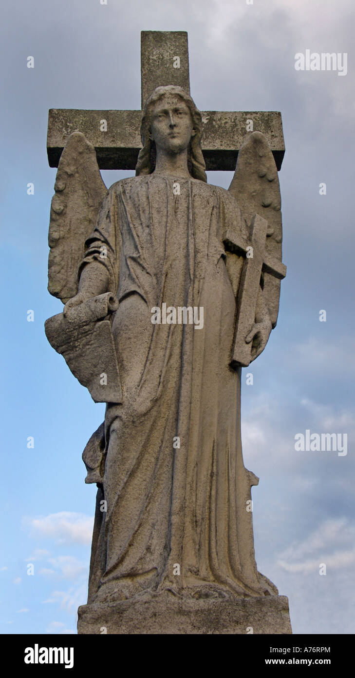 Angel and cross Victorian gothic tombstone in Brompton cemetery London England Stock Photo