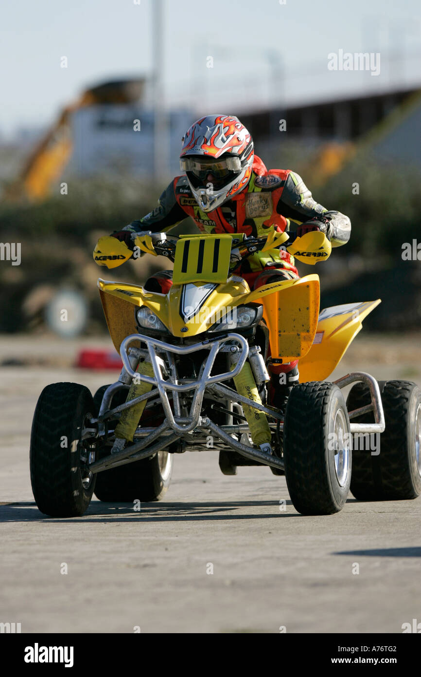 Quad Racing Yellow quad racer on his yellow bike at the Motorcycle and Karting show ...