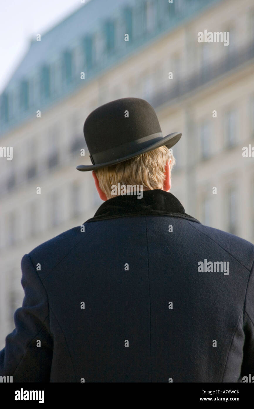Man with bowler hat in winter in front of the Hotel Adlon in Berlin, Germany Stock Photo