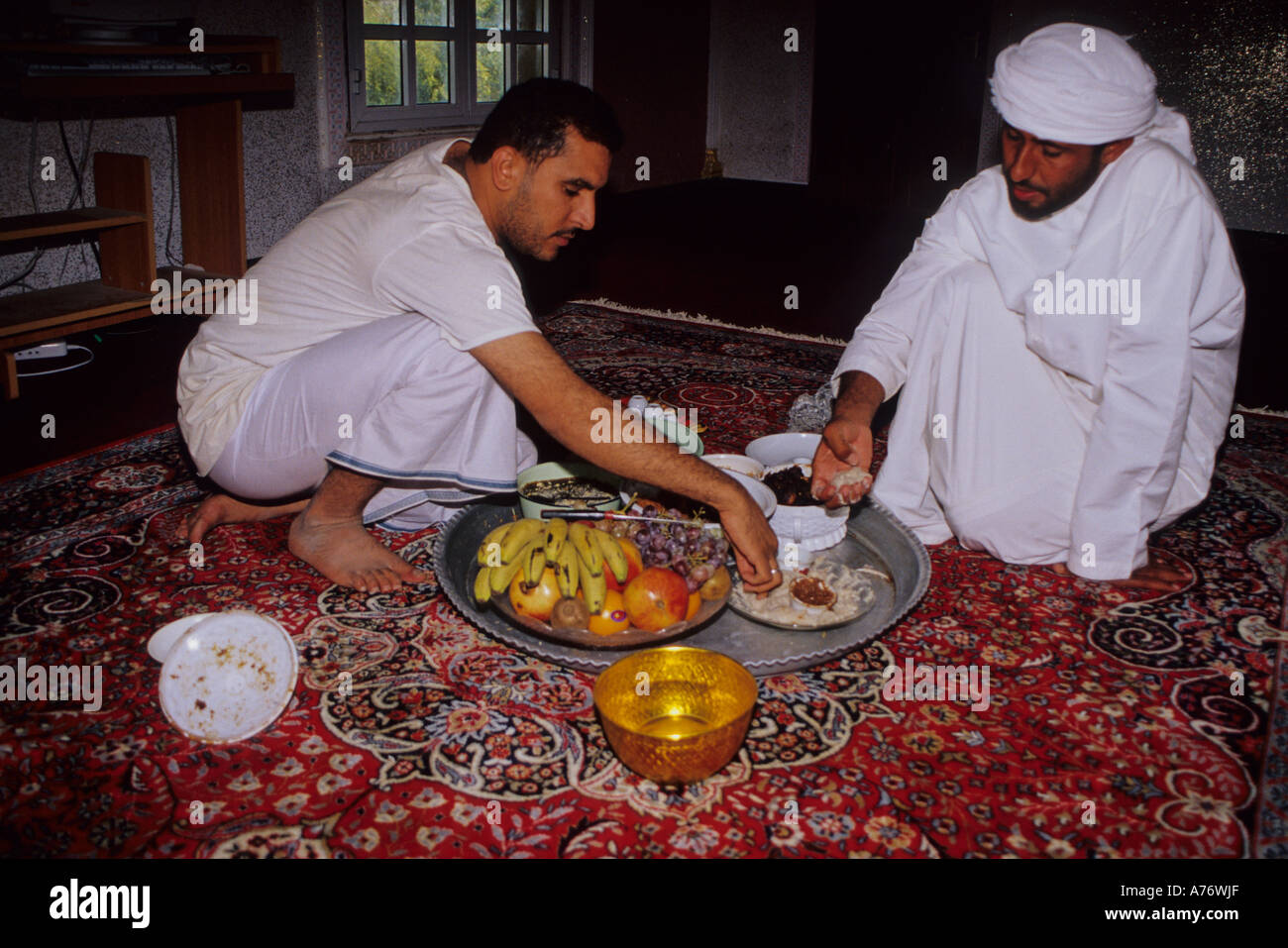 Men Taking Lunch on the Eid al-Adha Feast of the Sacrifice, Mudayrib, Oman Stock Photo