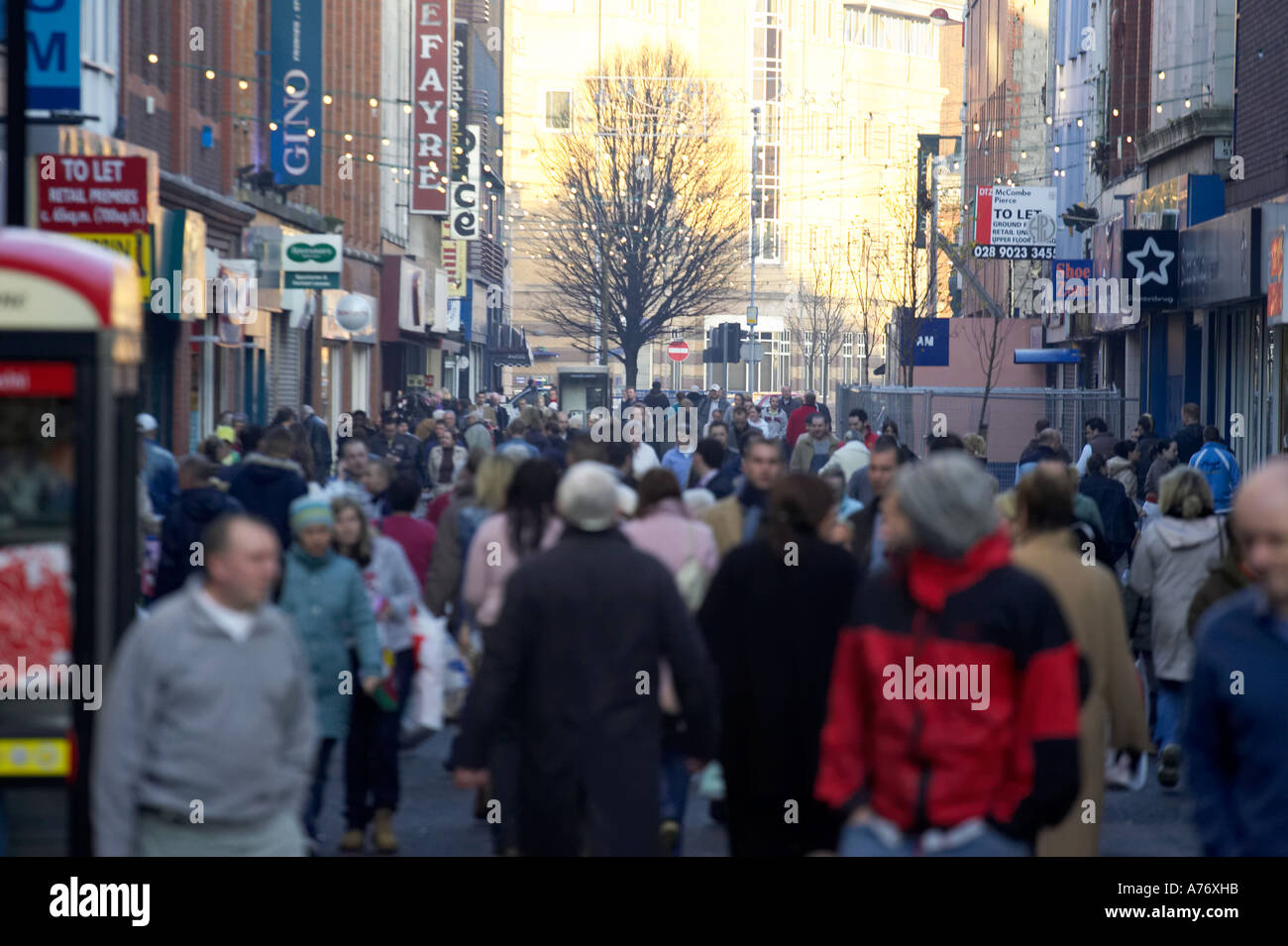 busy crowd out christmas shopping in pedestrian area of Ann Street Belfast Christmas Eve Northern Ireland Stock Photo