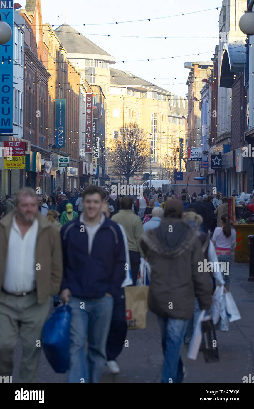 busy crowd out christmas shopping in pedestrian area of Ann Street Belfast Christmas Eve Northern Ireland Stock Photo
