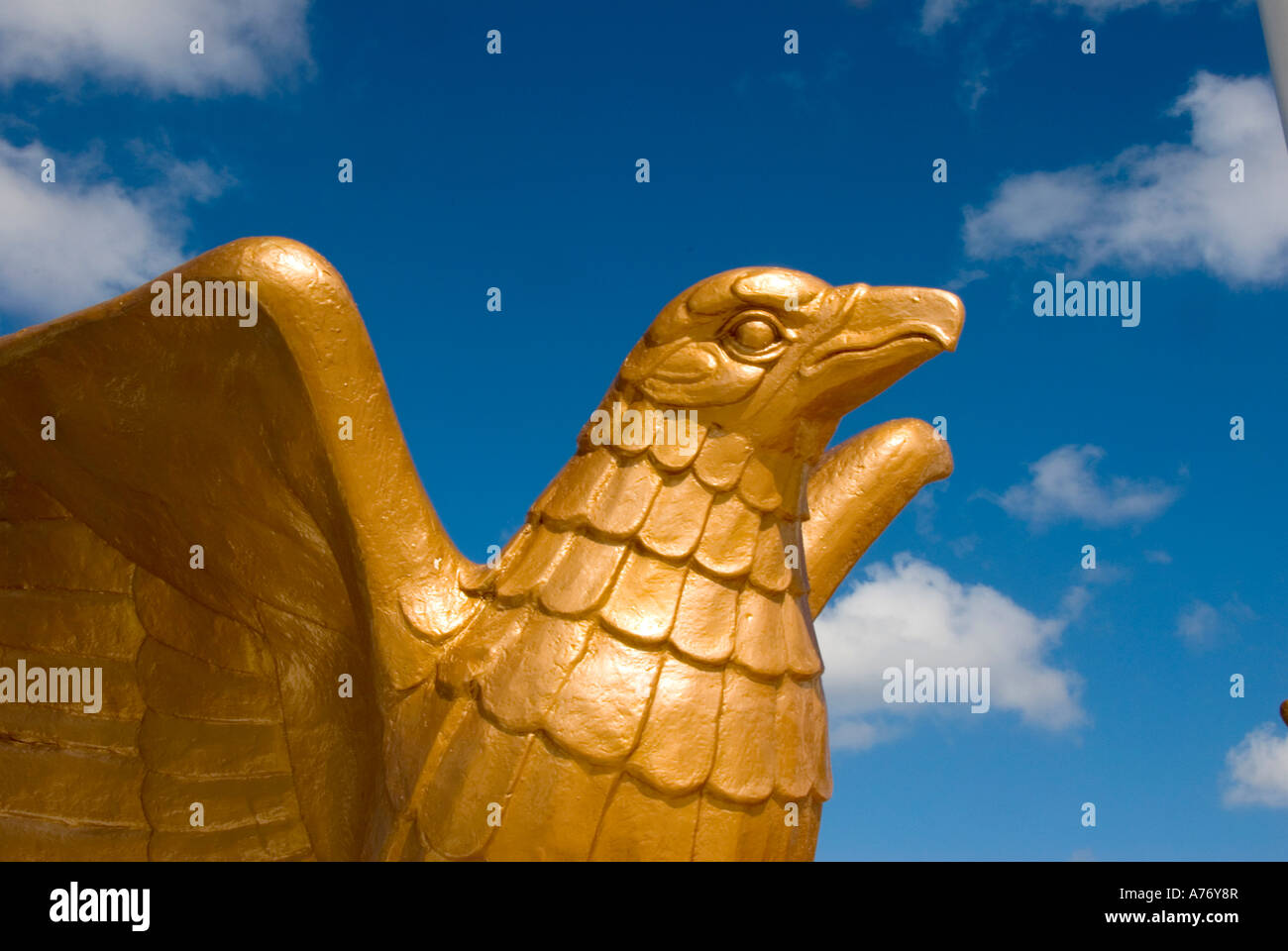 Cozumel Mexico San Miguel town bright yellow golden eagle statue at malecon Stock Photo
