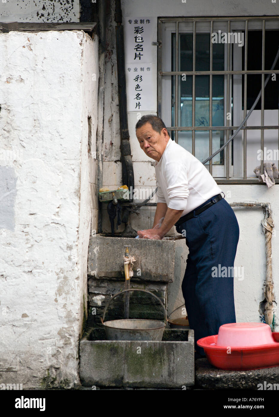 China Shanghai Elderly Chinese Man Washing Clothes In A