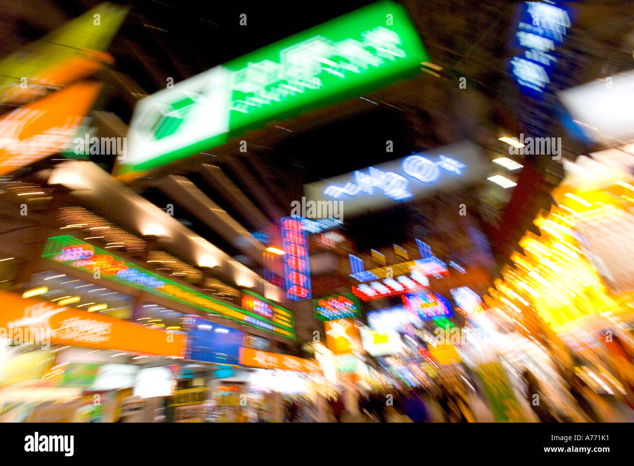 Neon signs and shopping street at night in Hong Kong with motion blur ...