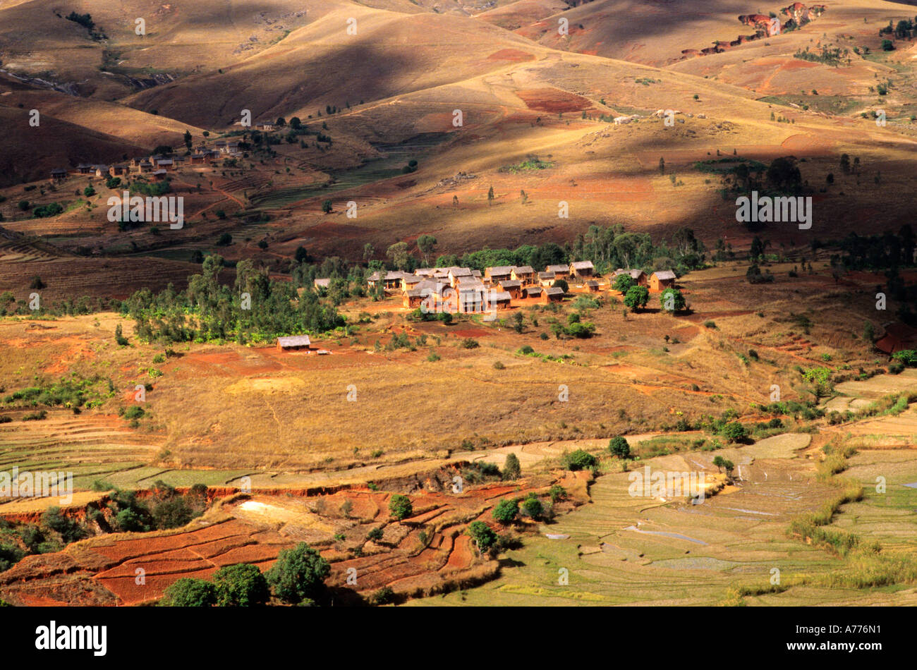 Small village in central highlands of Madagascar with deforested hills and terracing Stock Photo