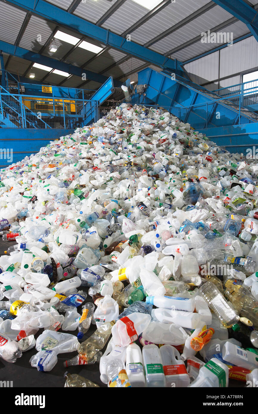 Used plastic bottles on conveyor belt in factory Stock Photo