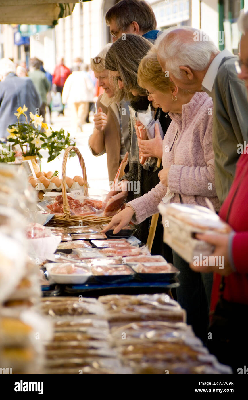 Shoppers buying fresh organic  local meat, eggs  and other food at Aberystwyth Farmers Market, Ceredigion Wales UK Stock Photo