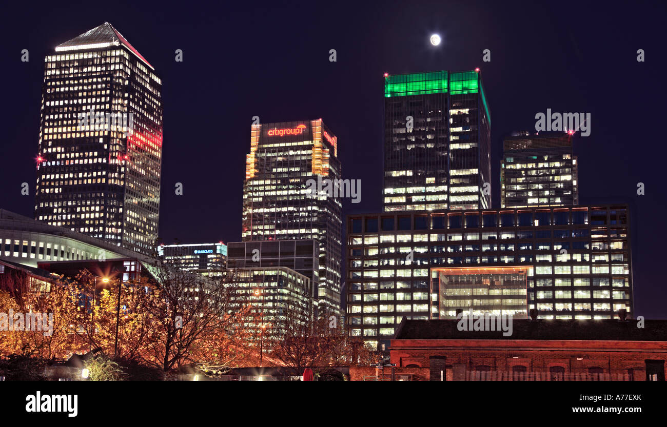 Night time view of Canary Wharf buildings with full moon Stock Photo