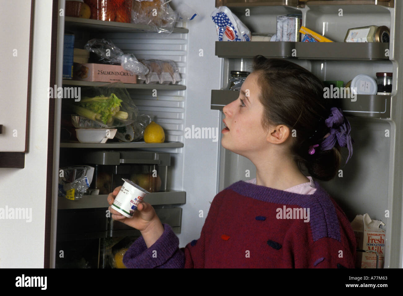 teenage girl looking in the fridge Stock Photo Alamy