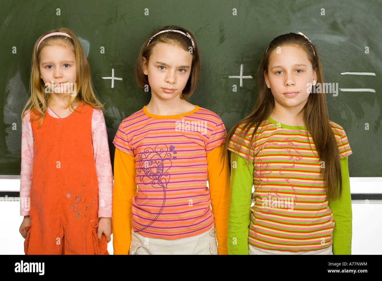13yo girl  Group of girls 5 11 and 13yo are standing and looking at camera Behind them  there s greenboard with plus and equal signs Stock Photo - Alamy