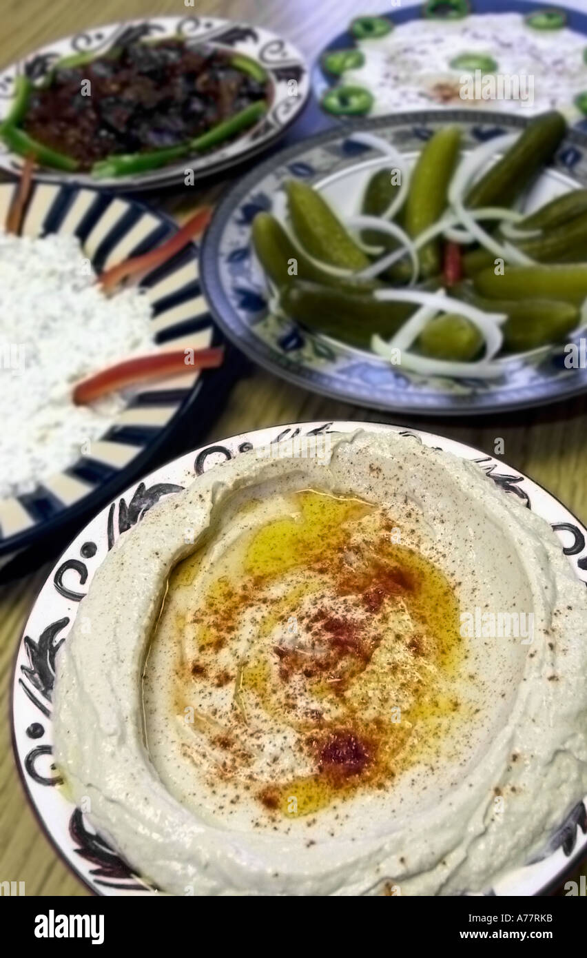 CLOCKWISE FROM FOREGROUND HUMMUS BABAGANOUSH SPANISH EGGPLANT TAHINI