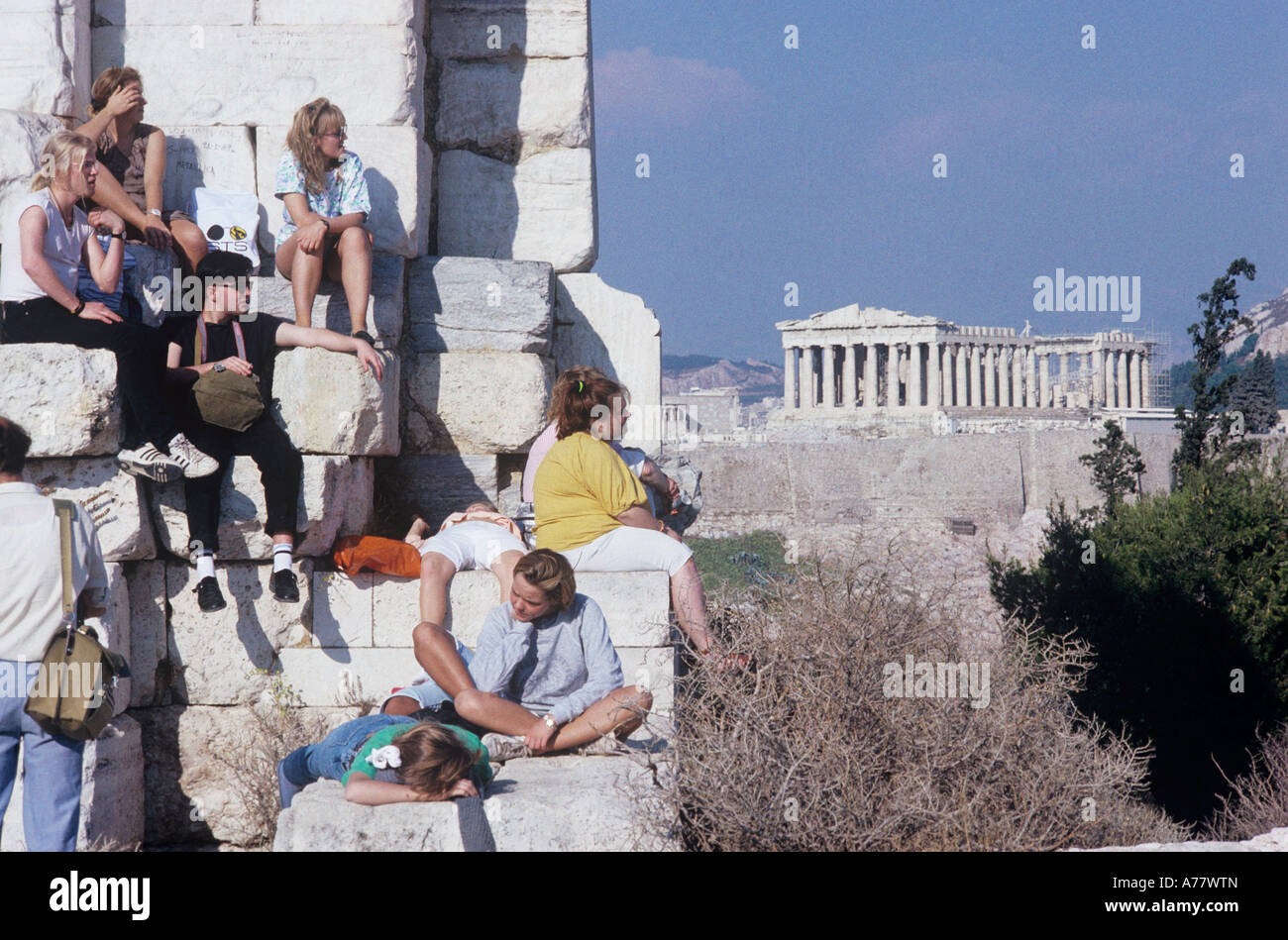 Greece,Athens, The Parthenon seen from Mount Philopappus is covered with resting youth. This is a popular spot for both reasons Stock Photo