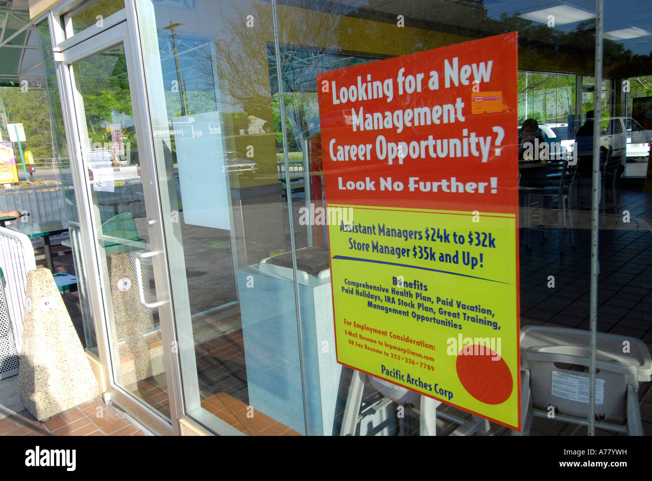 Help wanted poster posted in the window of a fast food restaurant Stock Photo