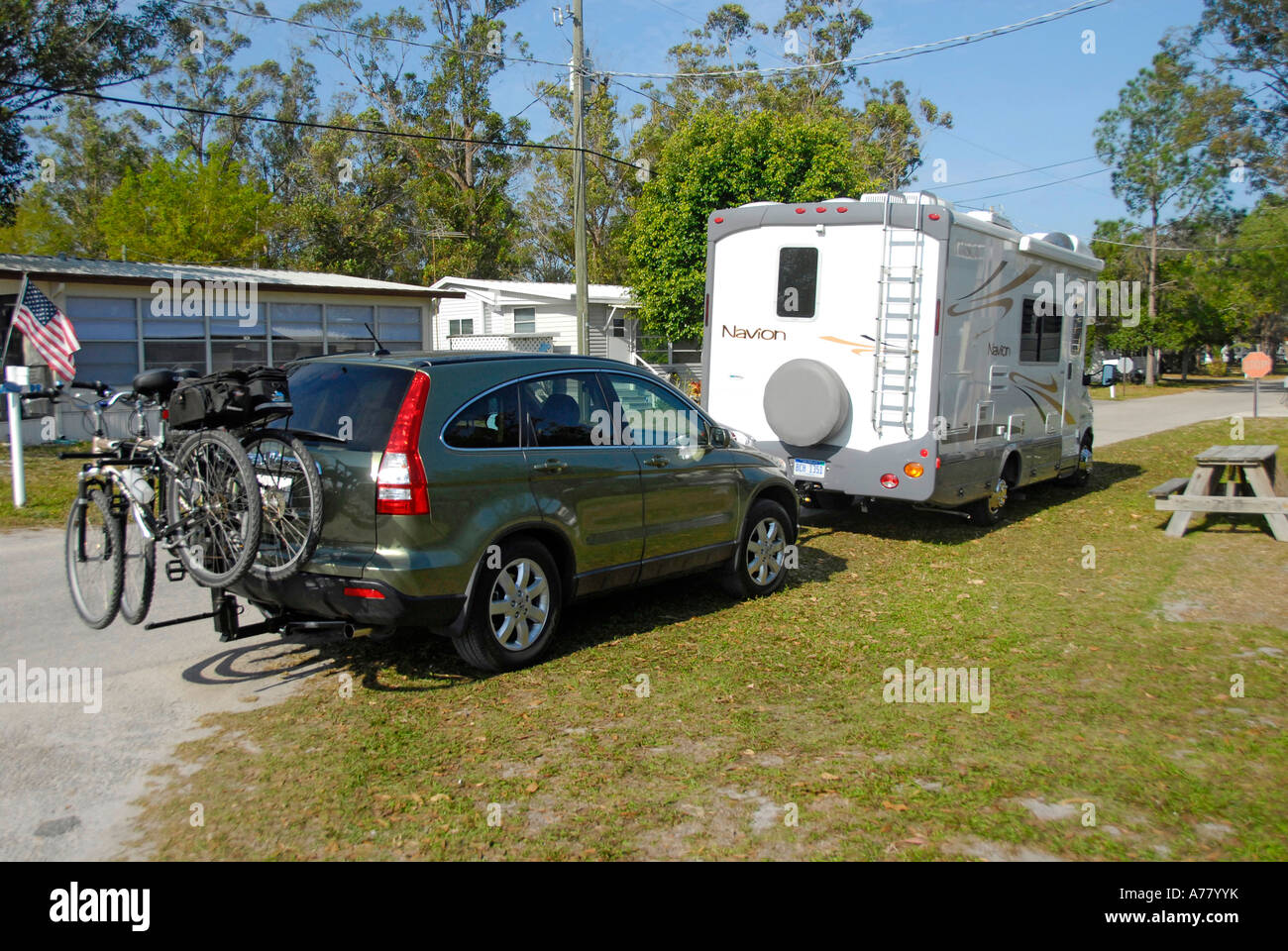 Motorhome preparing to tow an automobile while traveling Stock Photo