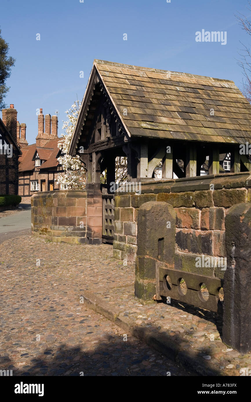 UK Cheshire Vale Royal Great Budworth village stocks at St Marys Parish church lych gate Stock Photo