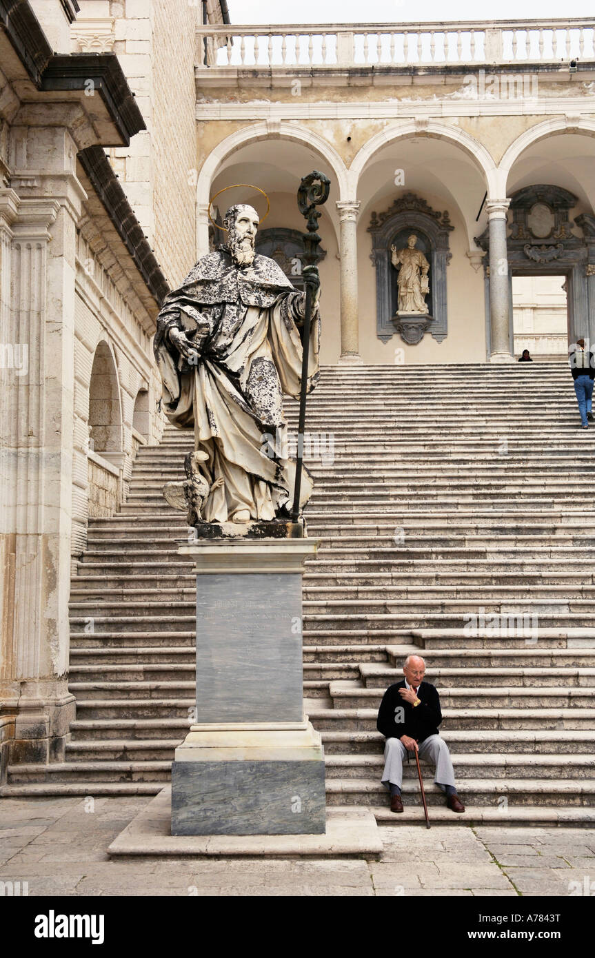 A man sitting on the steps to the church at Monte Cassino in Italy Stock Photo