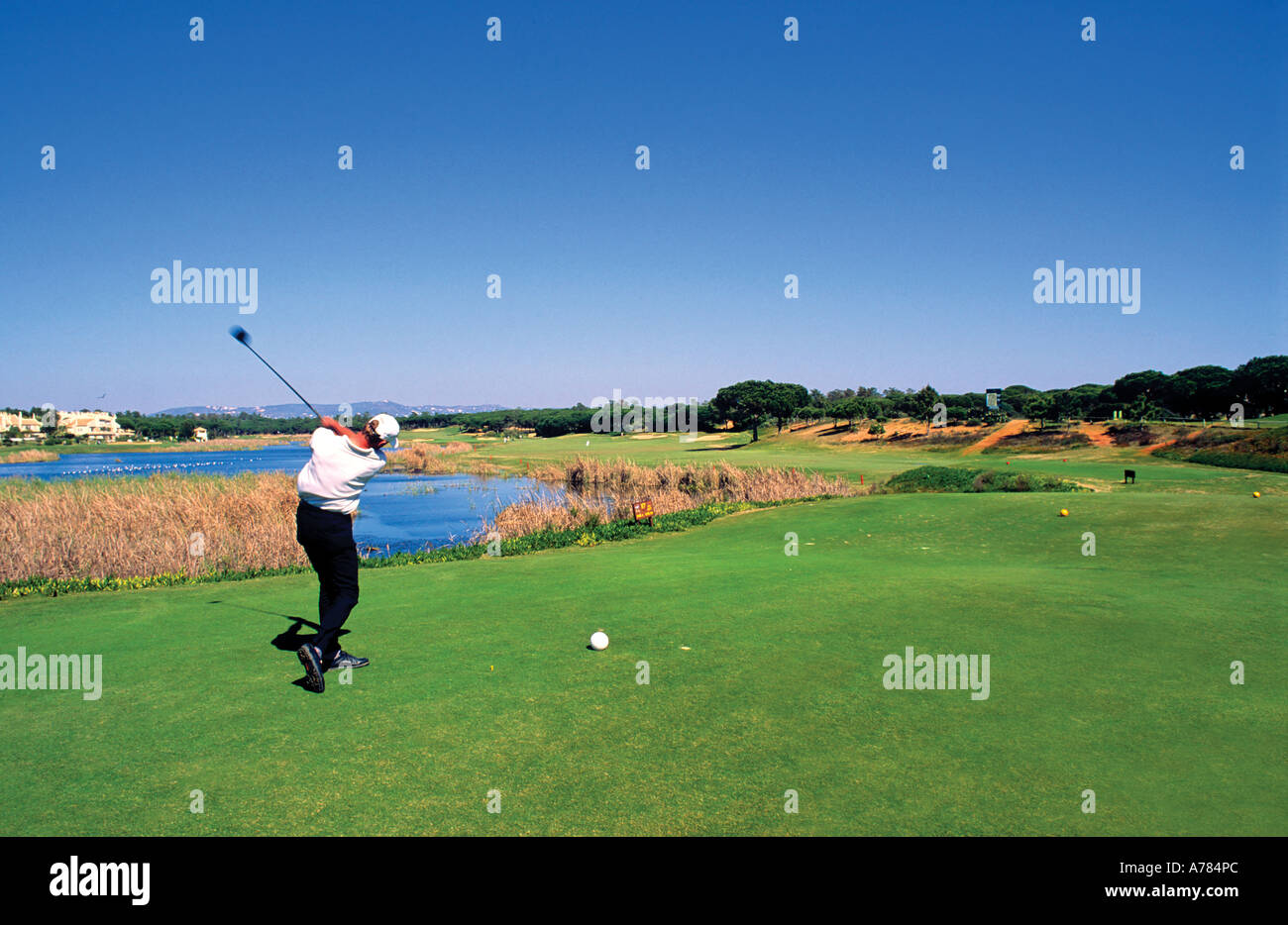 Golfer shooting ball Quinta do Lago Faro Algarve Portugal Stock Photo