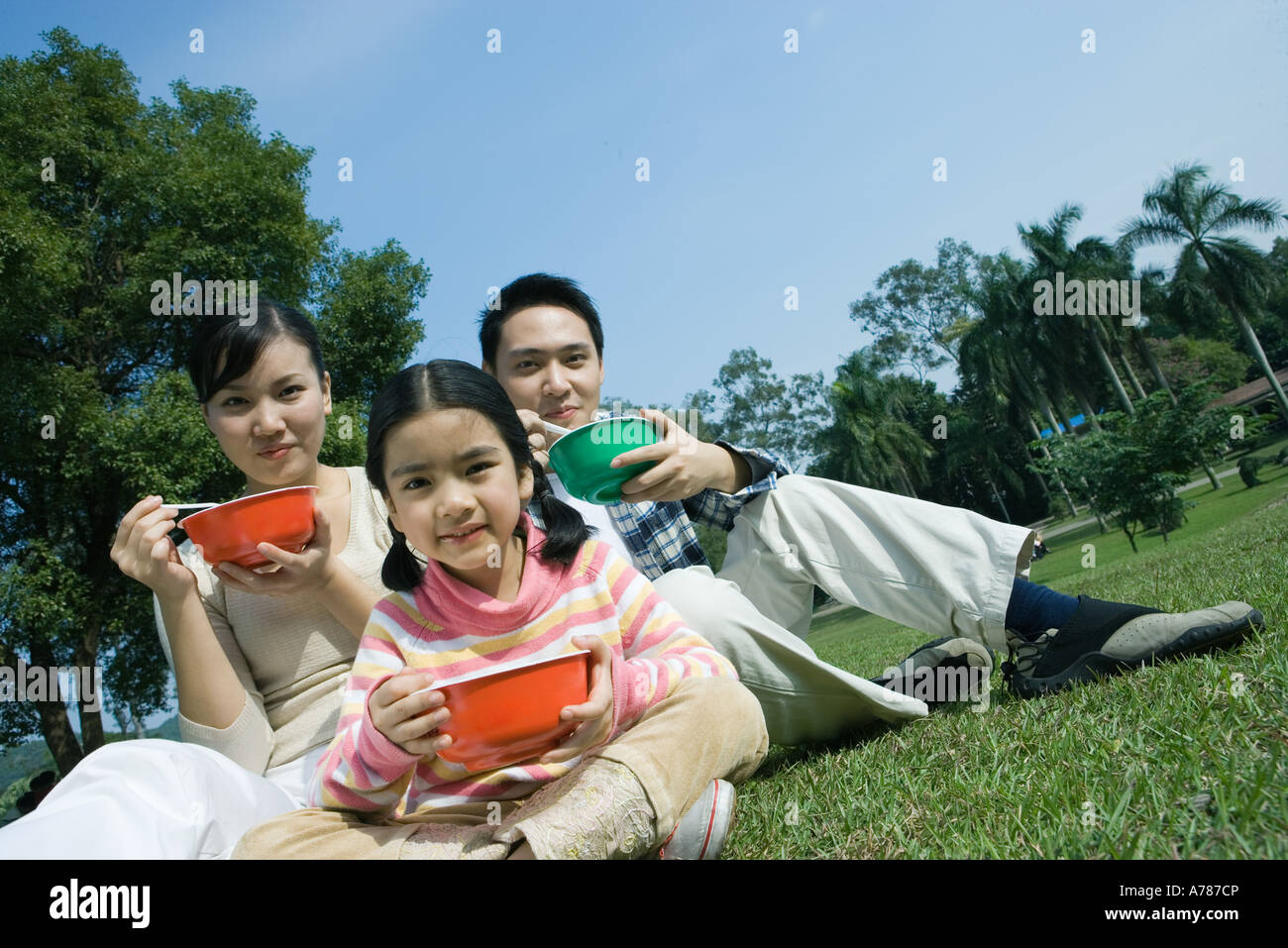 Family eating meal in the park Stock Photo