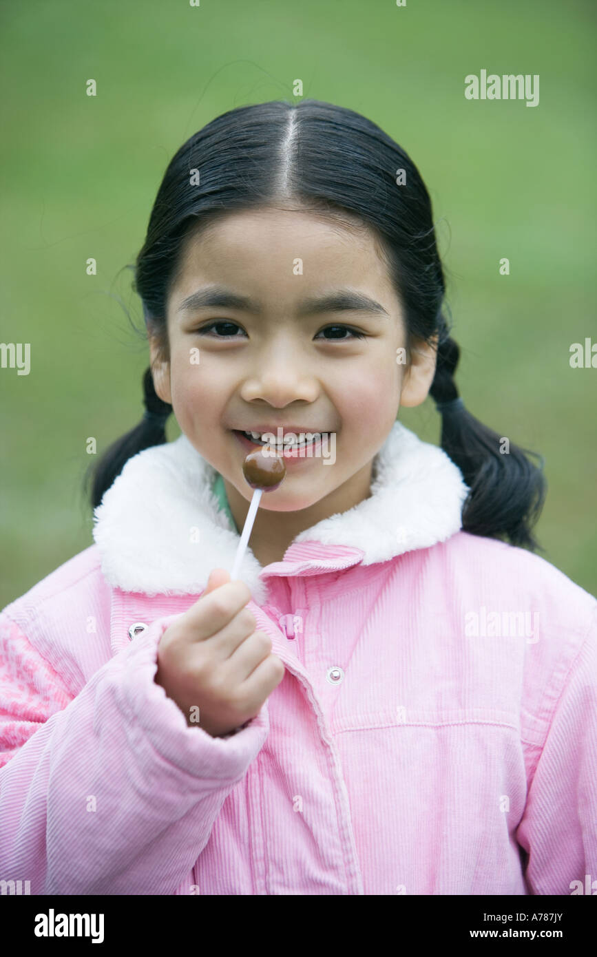 Girl holding lollipop, portrait Stock Photo