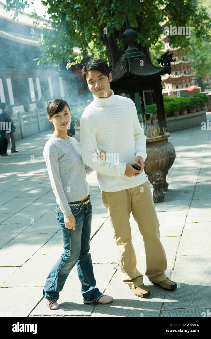 Couple standing near temple, full length, looking at camera Stock Photo