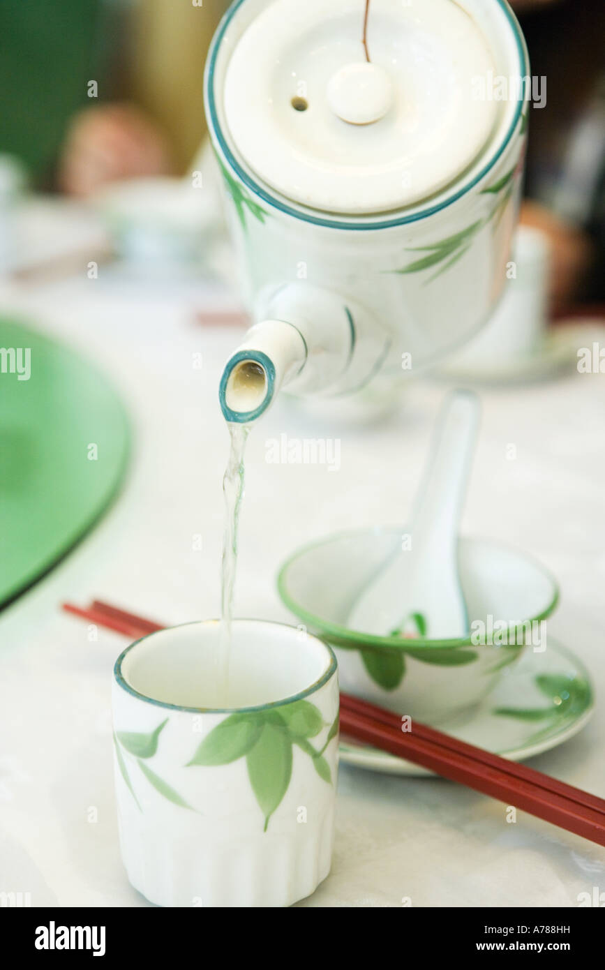 Pouring tea from teapot Stock Photo Alamy