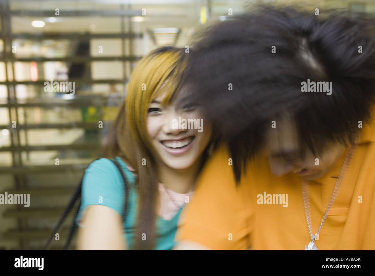 Young couple laughing, blurred motion Stock Photo