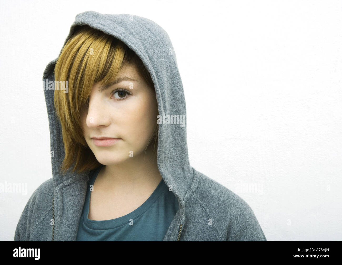 Young woman wearing hood, looking at camera, portrait Stock Photo Alamy