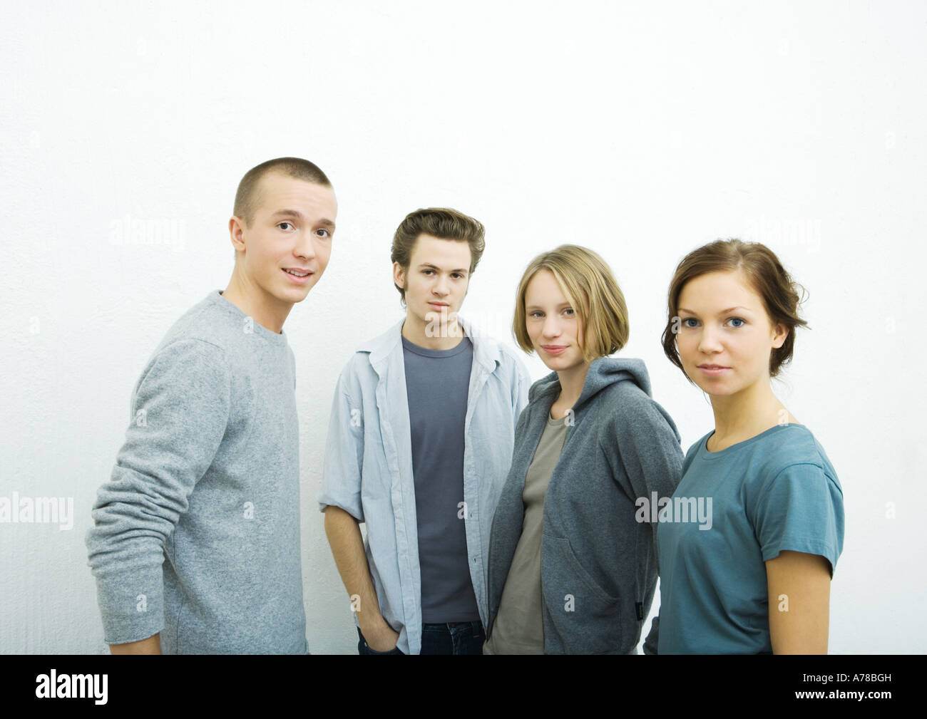 Four young friends, looking at camera, portrait Stock Photo