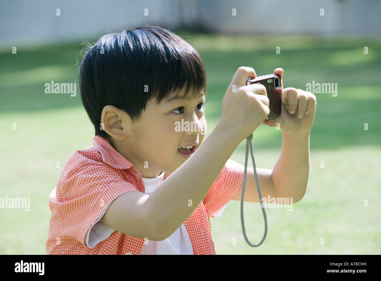 Boy taking photo with digital camera Stock Photo - Alamy