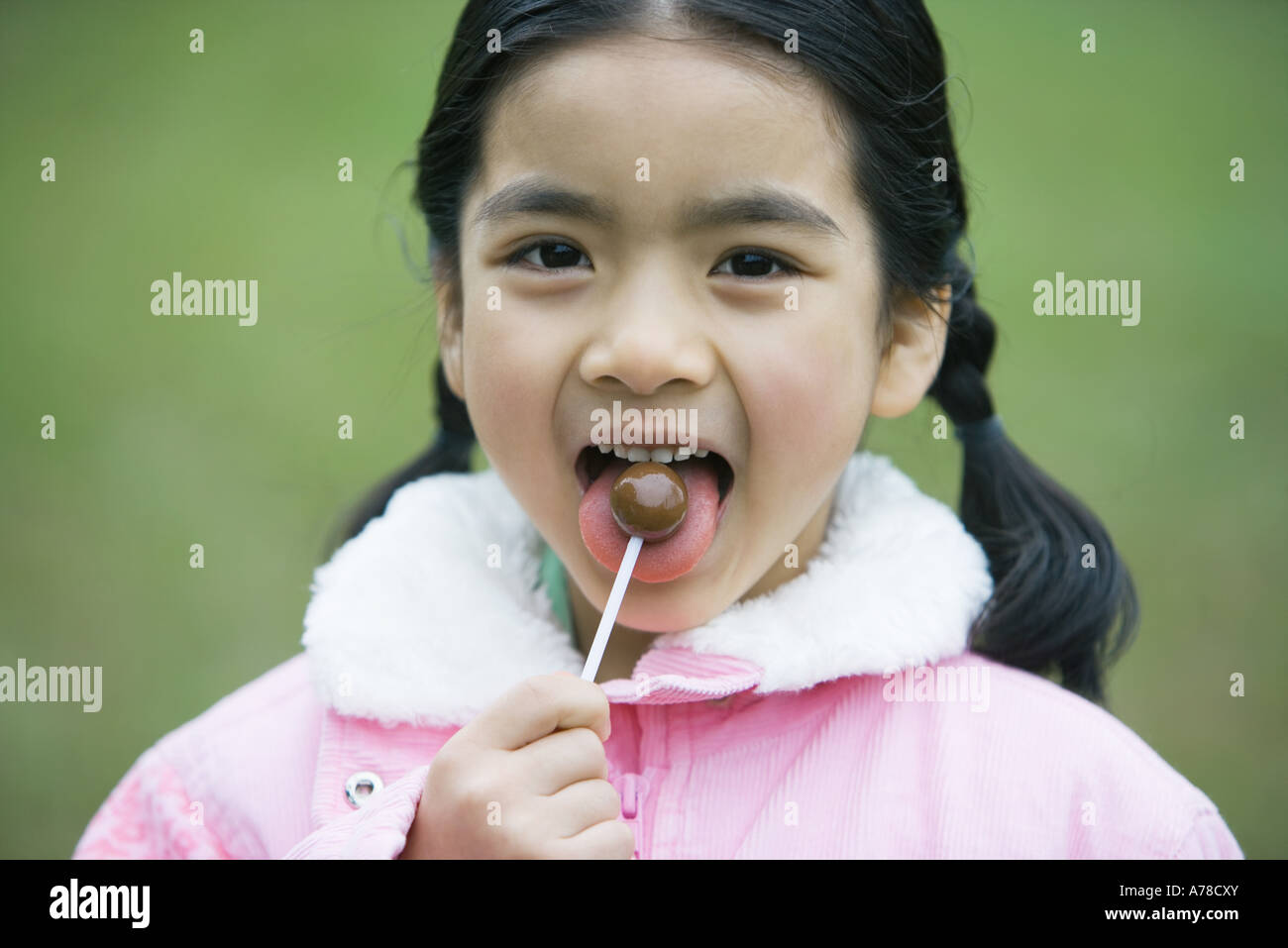 Girl eating lollipop Stock Photo