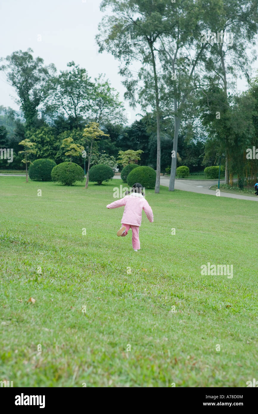 Little girl running across grass, rear view Stock Photo Alamy