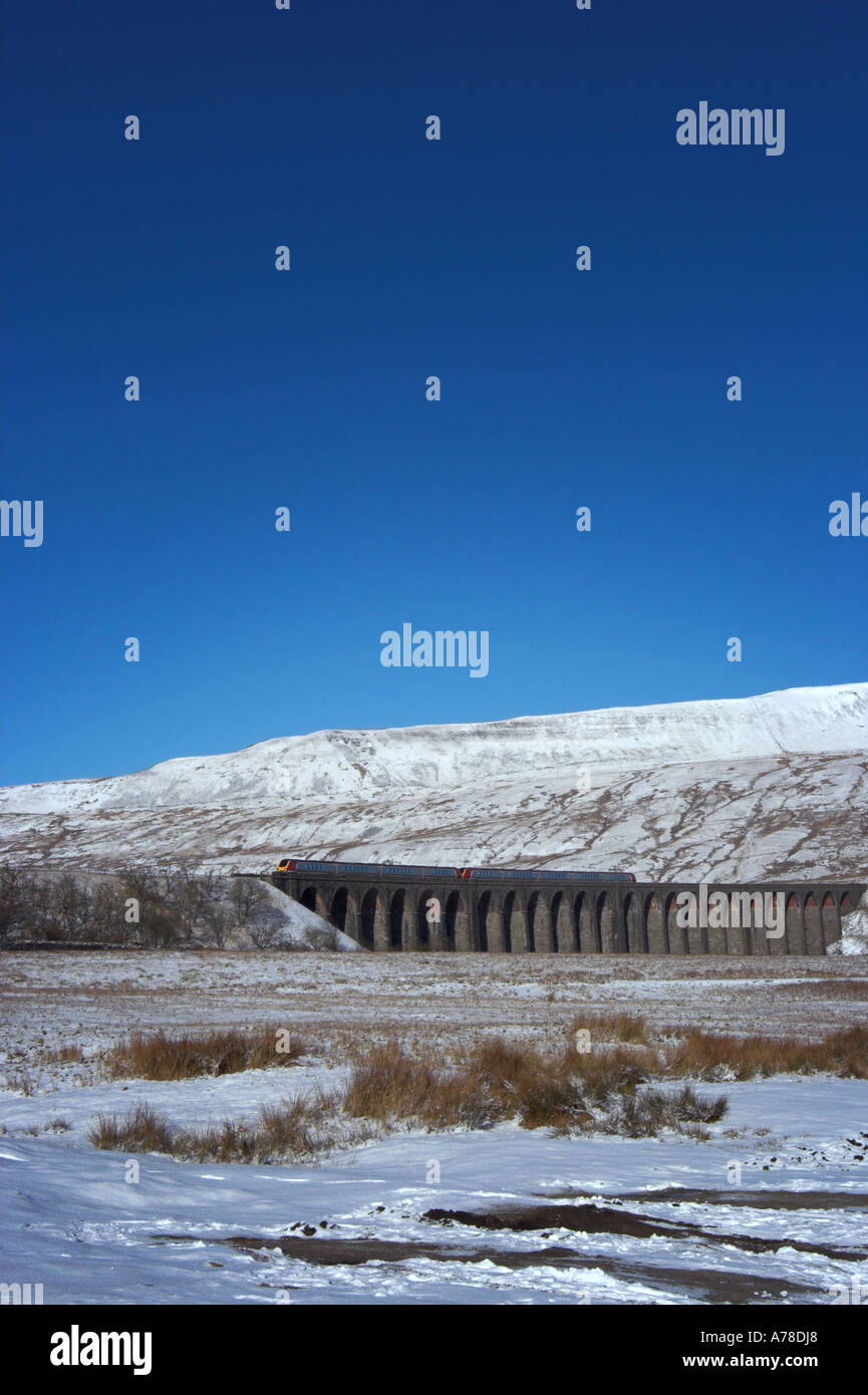 Virgin Voyager train crossing Ribblehead Viaduct in the Yorkshire Dales in winter Stock Photo