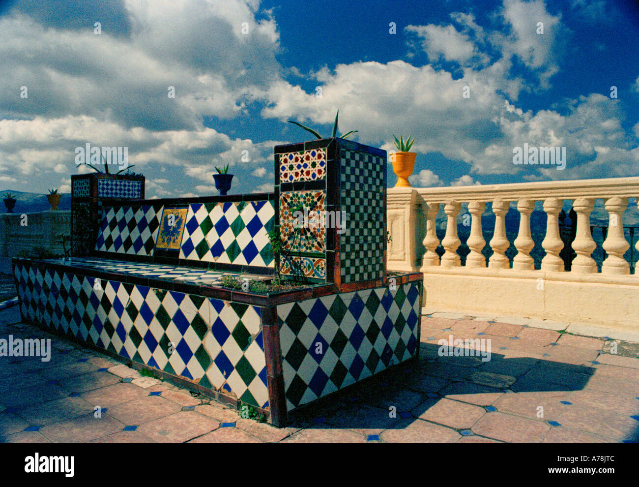 A tiled bench on a terrace overlooking the gorge at Ronda, Andalusia, Andalucia, southern Spain Stock Photo