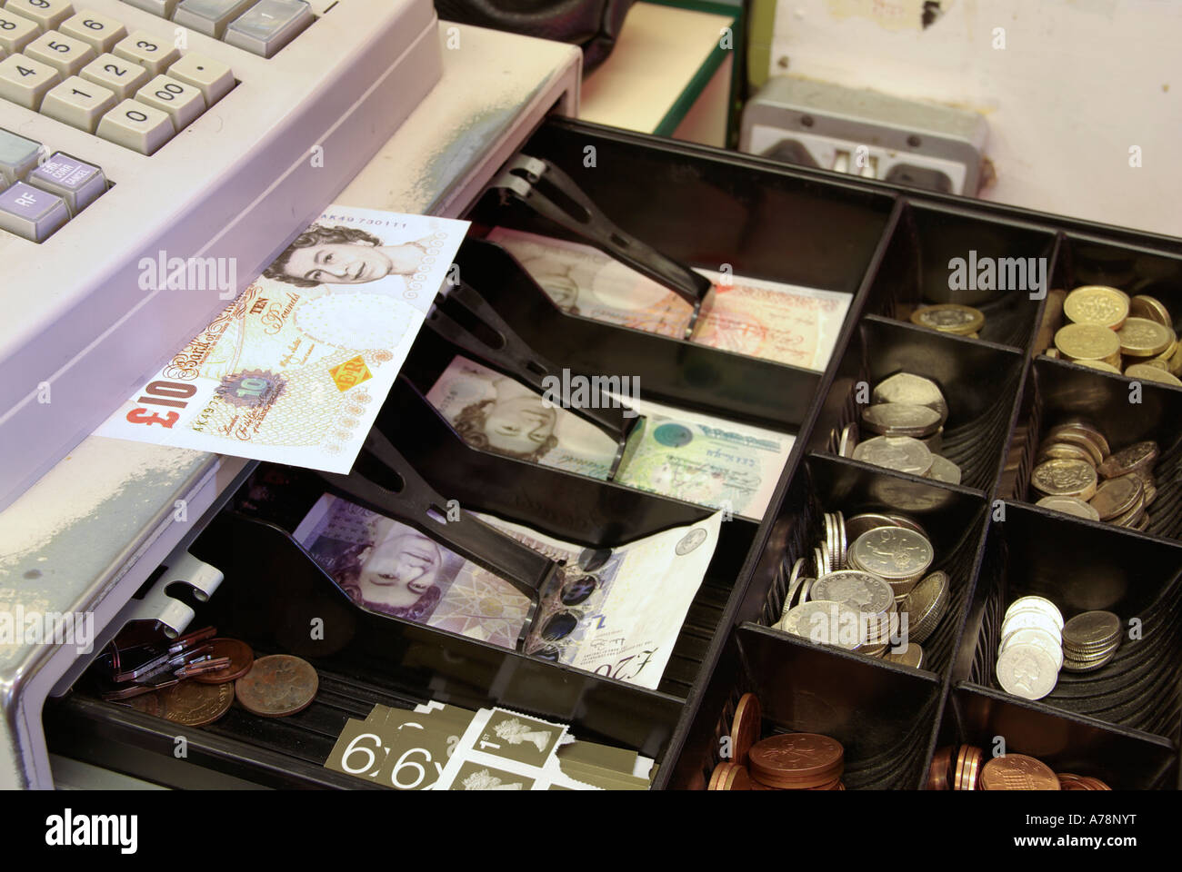 Open shop till in retail business premises showing £10 note on shelf includes £20 note & other legal tender England UK Stock Photo