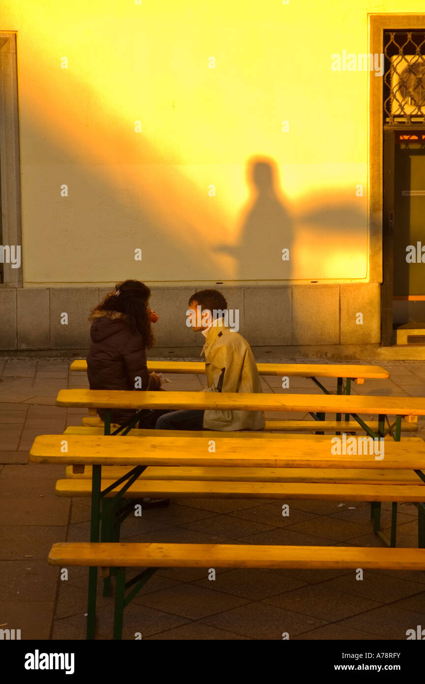 A couple sitting along Mariahilferstrasse in central Vienna Austria EU Stock Photo