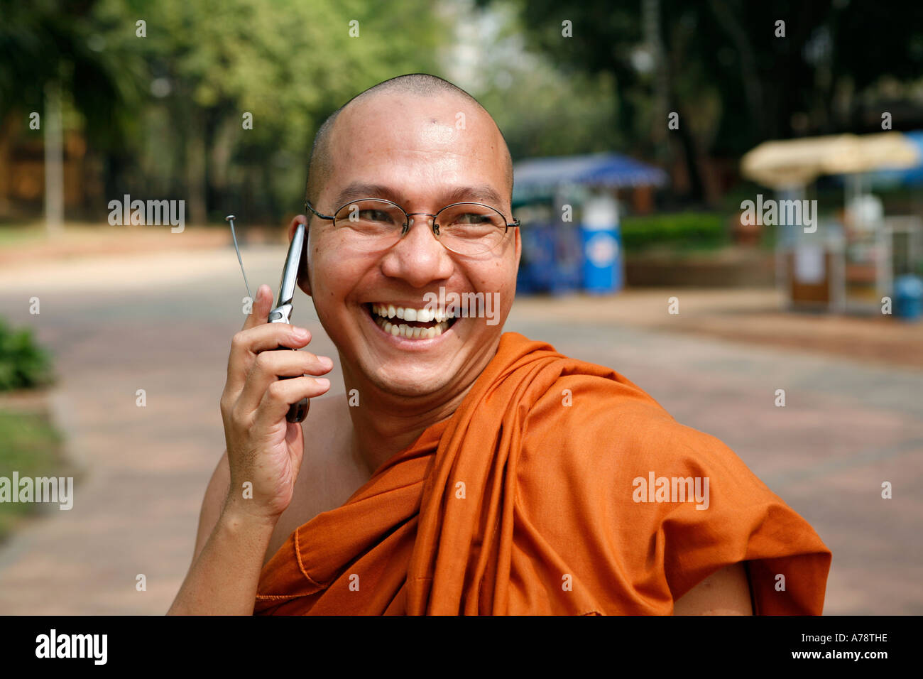 A laughing monk and his cell phone (Yangon, Burma (Myanmar) Stock Photo