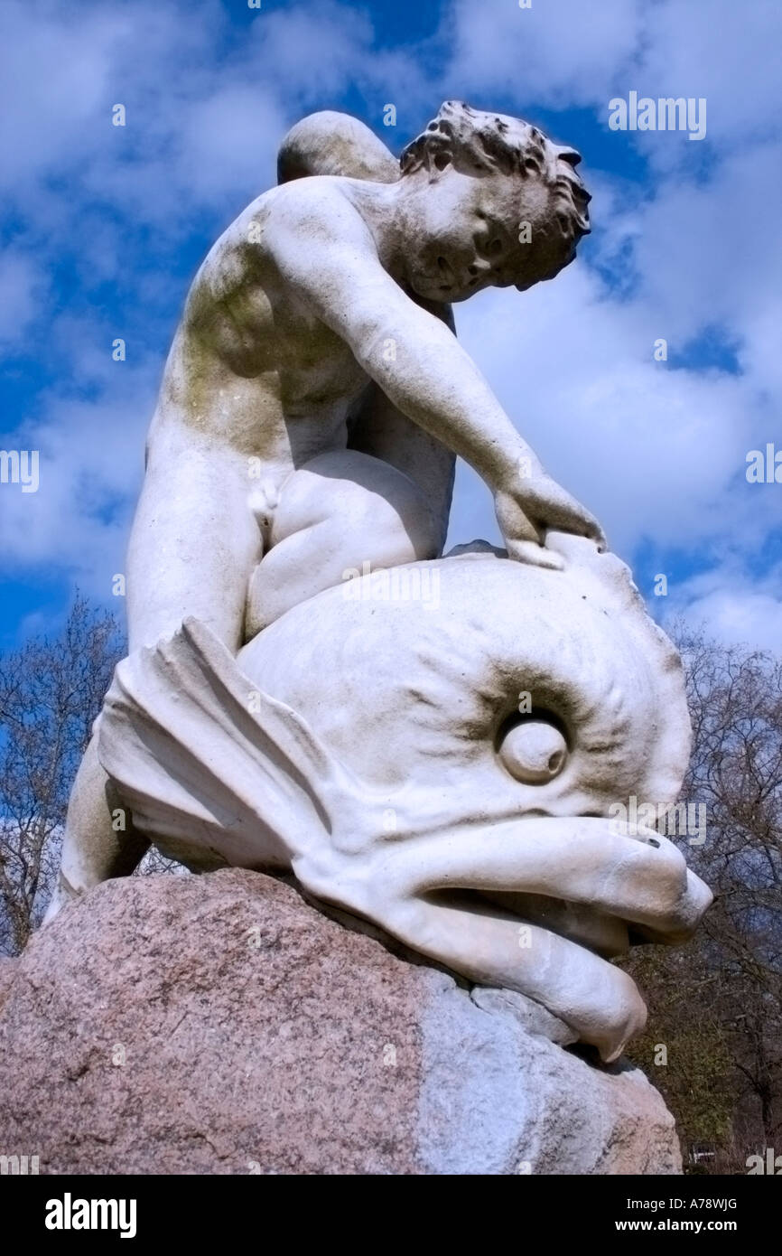 BOY AND THE DOLPHIN, unusual sculpture in Hyde Park, from 1863, by the pre-Raphaelite  artist, Alexander Munro. Stock Photo