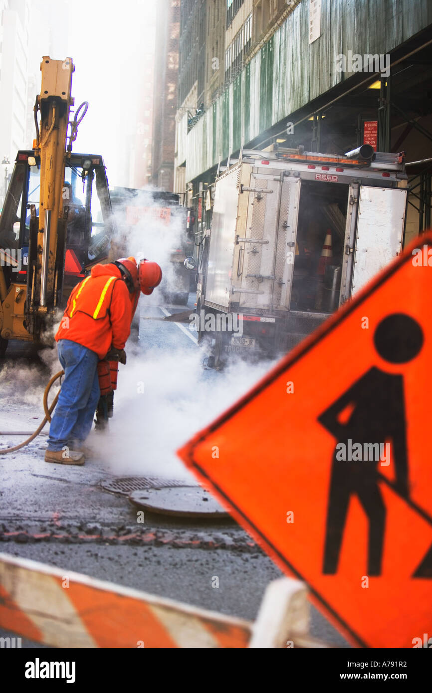 CONSTRUCTION WORKER WITH JACKHAMMER Stock Photo