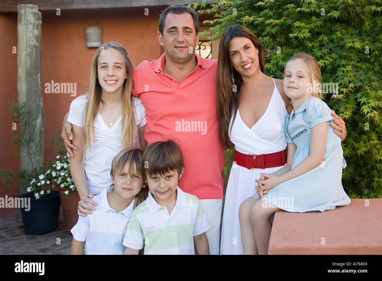 Family standing outside a house Stock Photo - Alamy