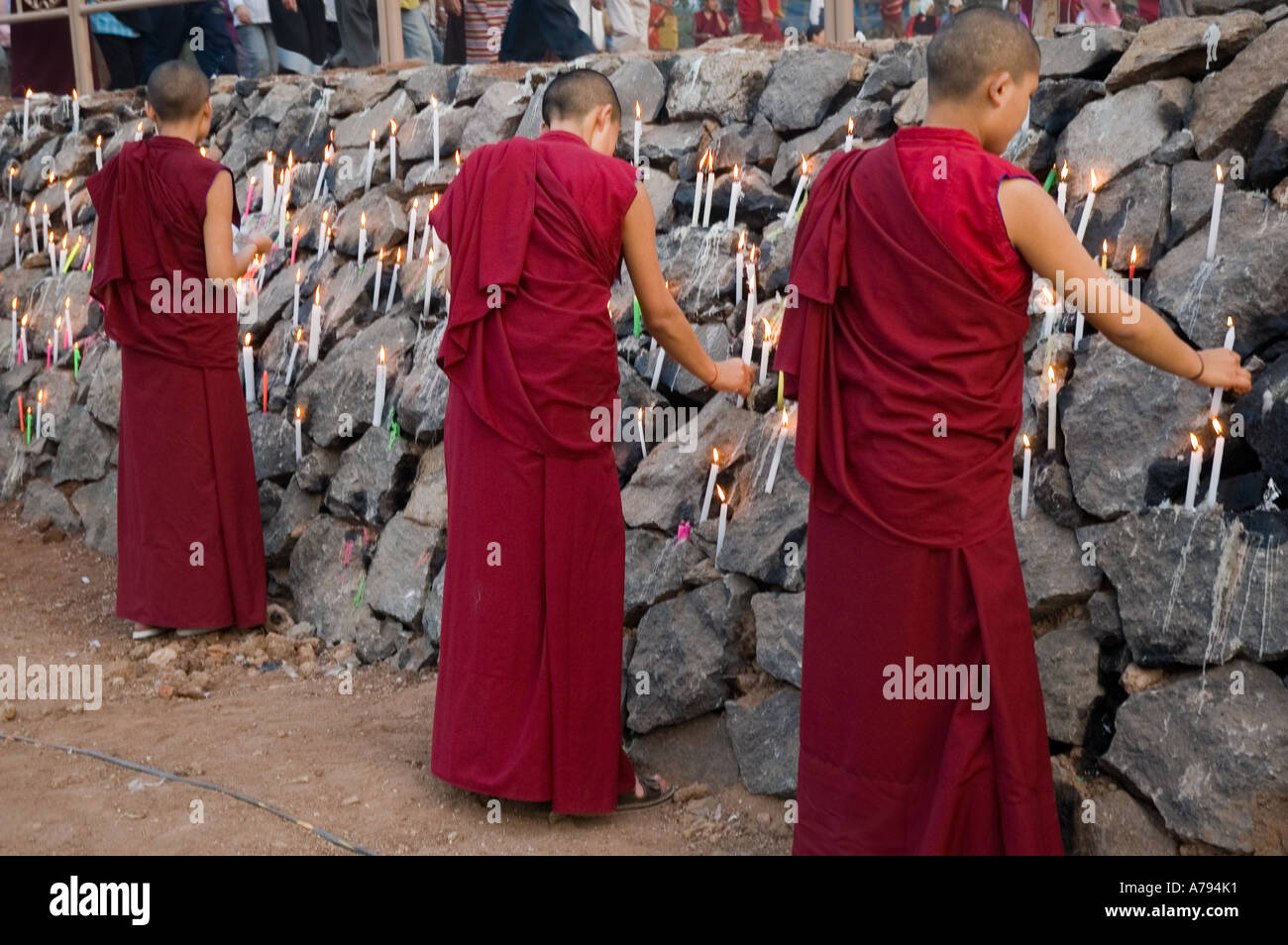 Tibetan female monks lights candles for ancestors at the Stupa Kalachakra ceremony Amaravati India Stock Photo