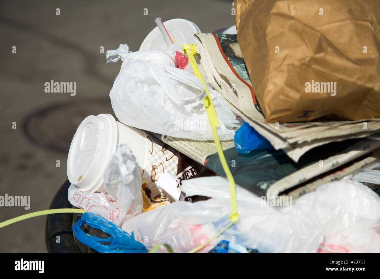 CHICAGO Illinois Garbage and trash piled in bin on sidewalk Old Town neighborhood Stock Photo