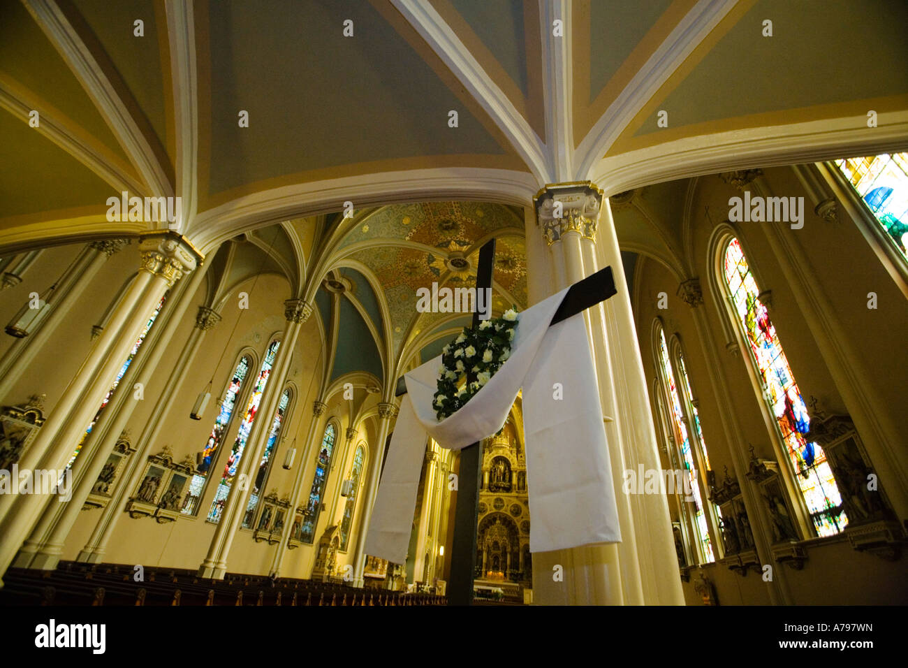 CHICAGO Illinois Interior of St Michaels Catholic Church draped cross lilies Easter stained glass windows Stock Photo