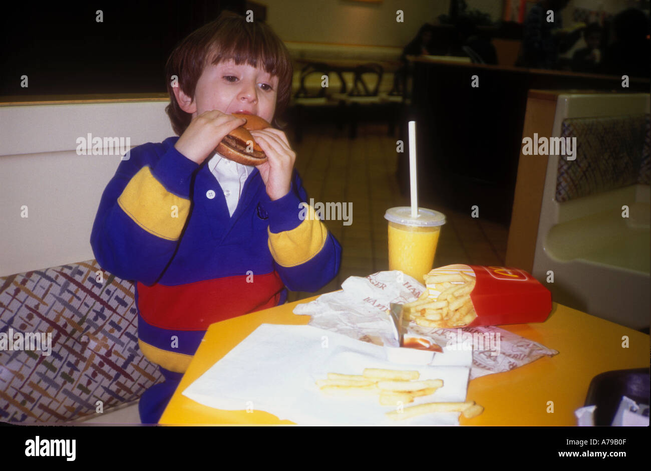 Young child eating fast food mcdonalds hires stock photography and images Alamy