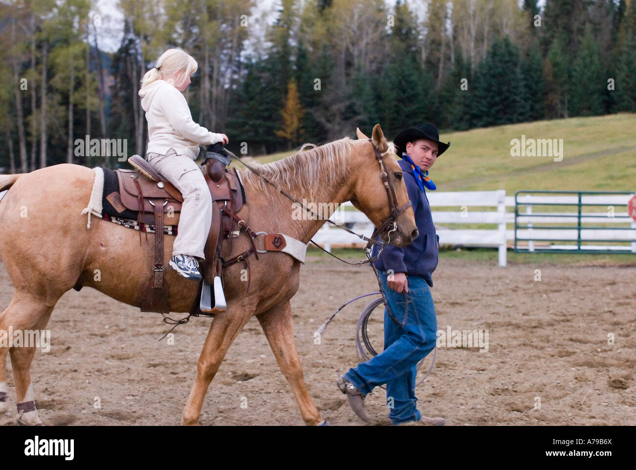 A young girl goes for a ride on a horse at a ranch near Horsefly BC Stock Photo