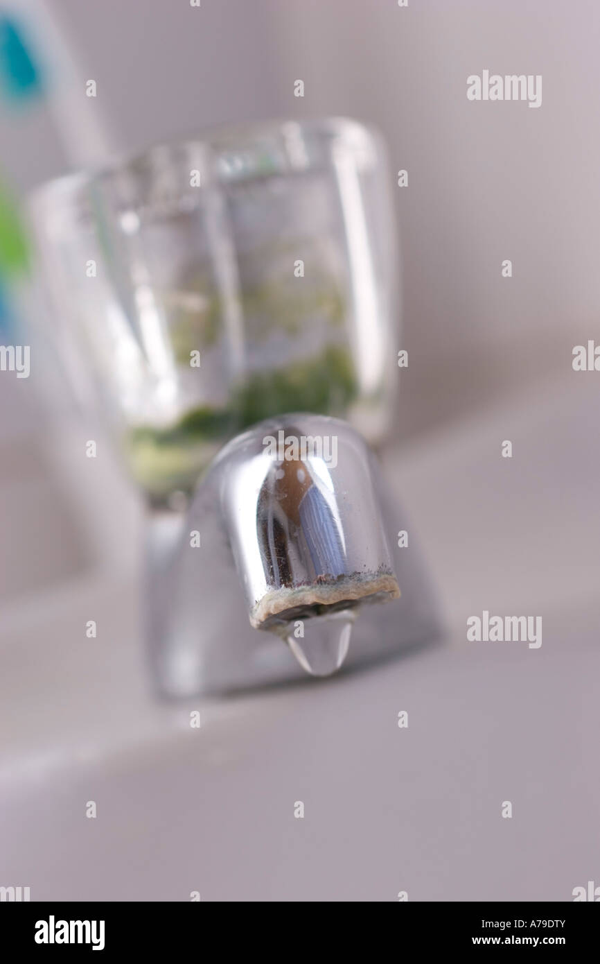 old dripping tap faucet with calcium carbonate fur limescale deposits